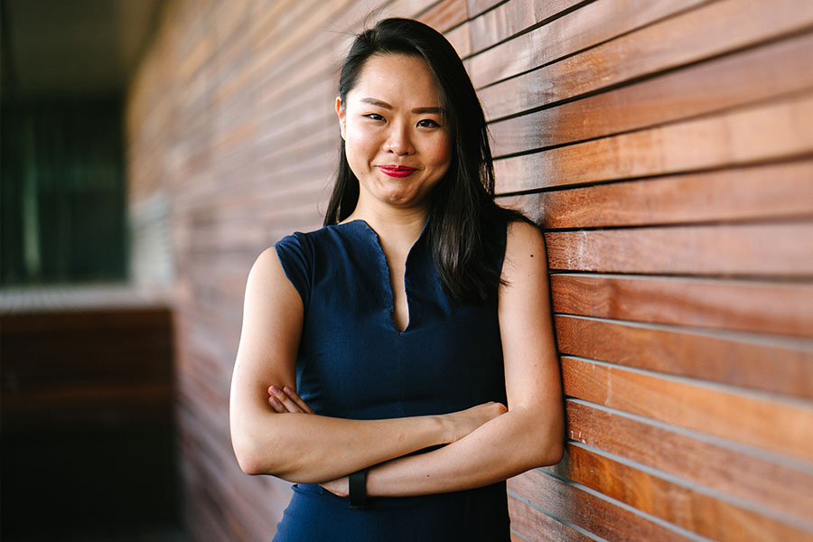 Woman Standing Against Wall with Arms Crossed Woman Standing Against Wall with Arms Crossed